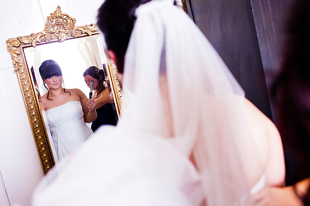 bride getting ready in mirror