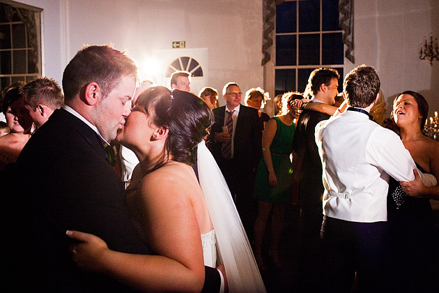 Bride and groom kissing on dancefloor