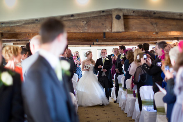 Groom Looks At Bride Walking Down The Aisle