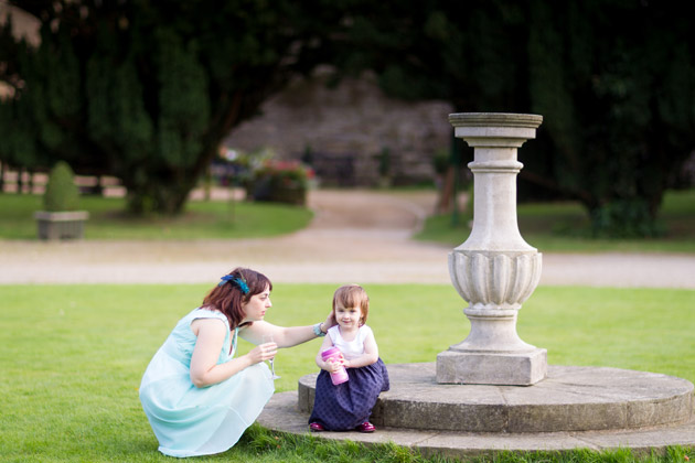 Wedding Guest With Little Girl by the Fountain