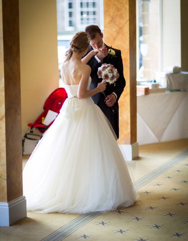 Romantic Groom Kissing Bride's Hand