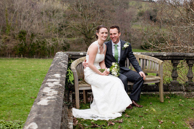 Bride and Groom Sitting on Bench