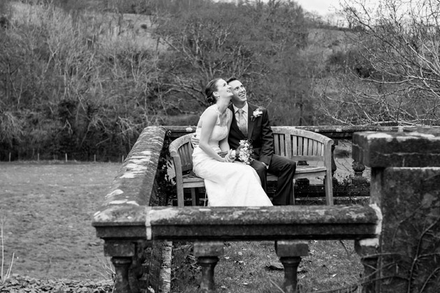 Bride and Groom Sitting on Bench