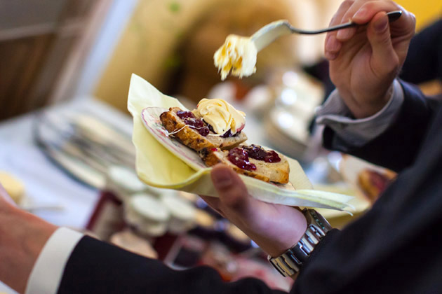 Guests Eating Scones with Clotted Cream and Jam