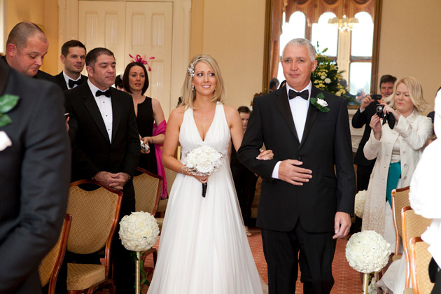 Bride And Father Of The Bride Walking Down The Aisle