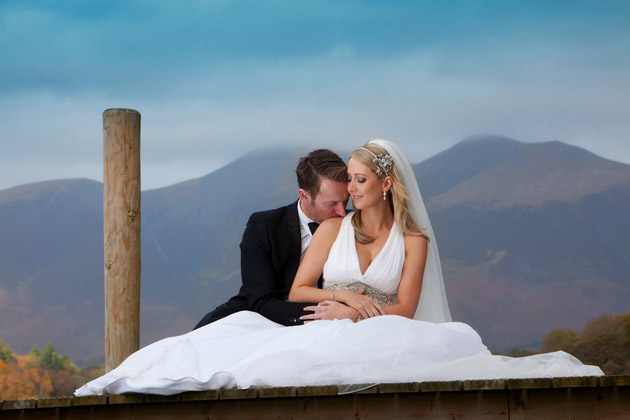 Groom Kisses Bride on Pier