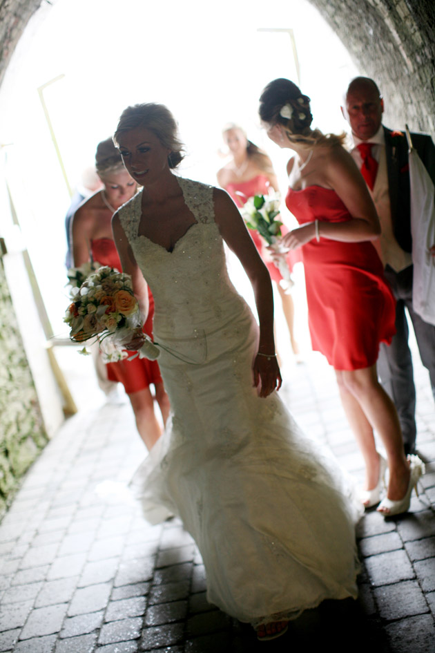 Bride and Bridesmaids Walk Through Tunnel to Ceremony