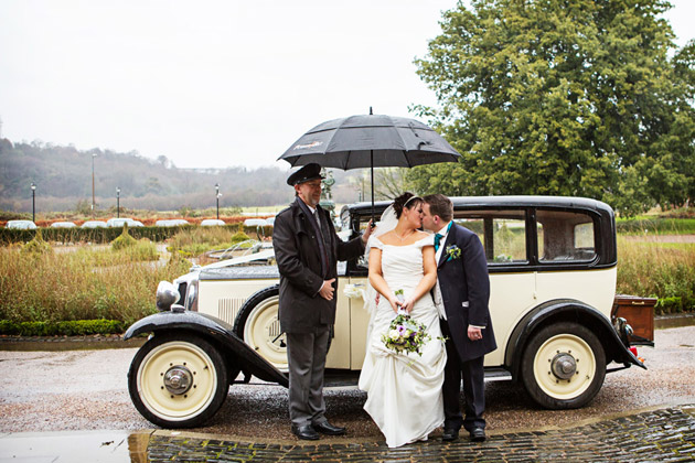 Bride And Groom With Brolly and Chauffeur