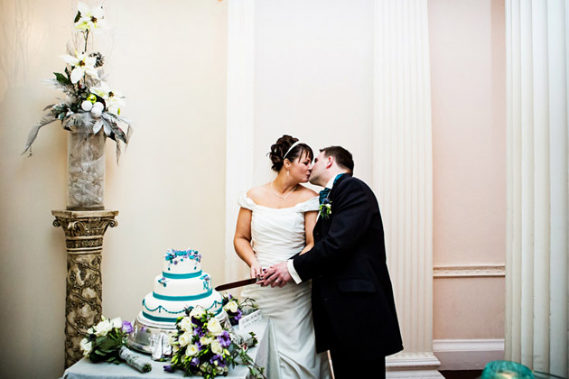 Bride And Groom Cutting The Cake