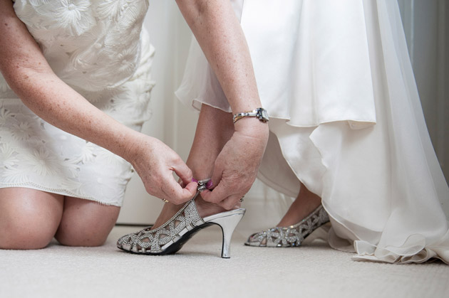 Mother of the Bride Helps Bride With Shoes