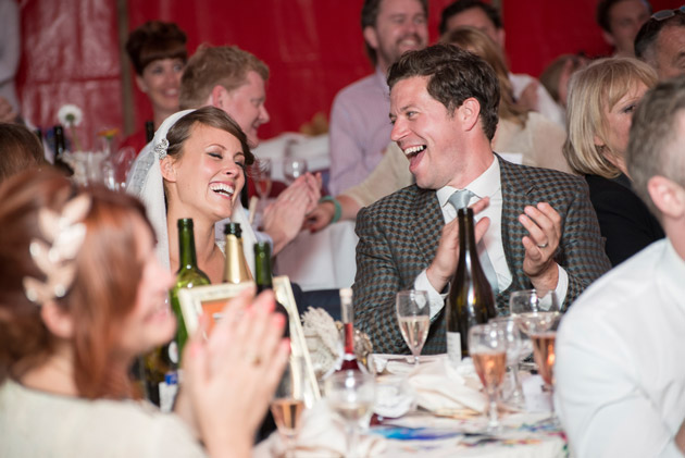 Bride and Groom Laughing at Speeches