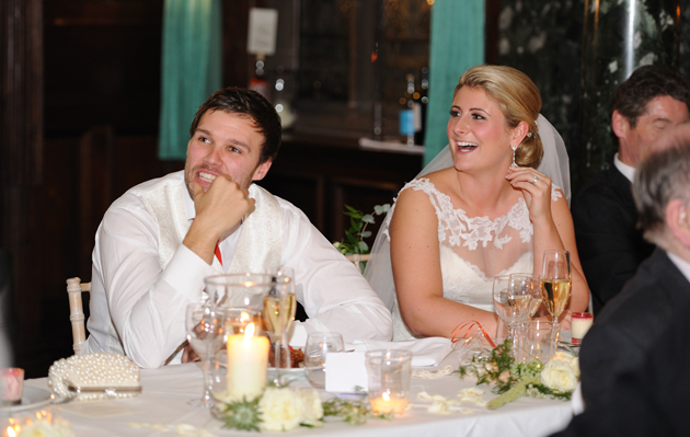 Bride and Groom Listen to Speeches