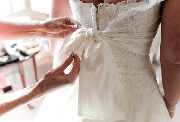 Bride Putting On Dress