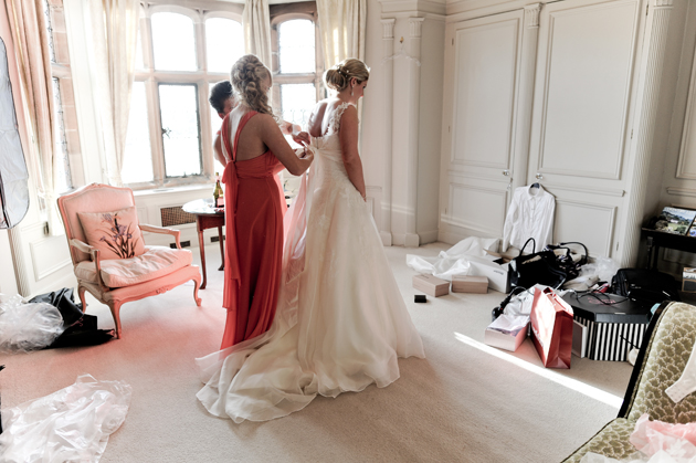 Bride Putting On Dress