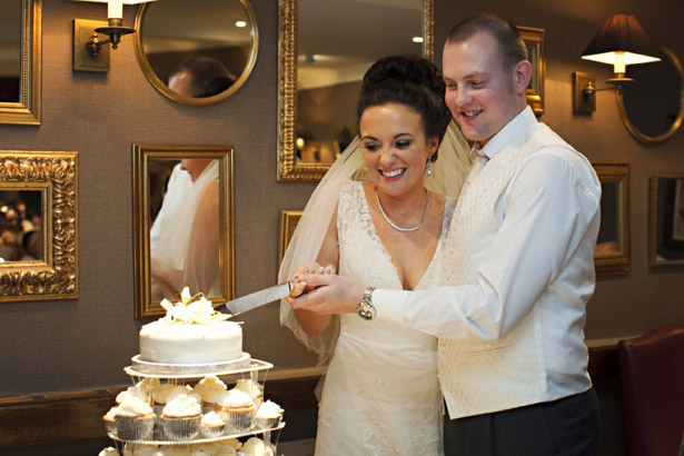 Newlyweds cutting the cake