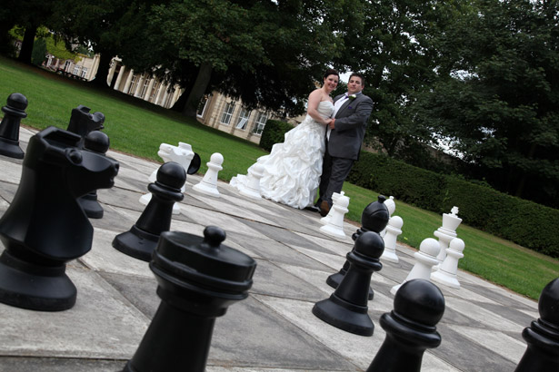 Bride and groom with giant chess set