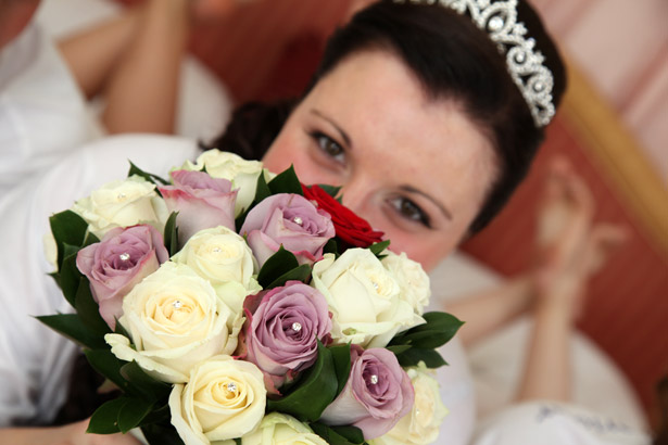 Bride with white and lavender bridal bouquet