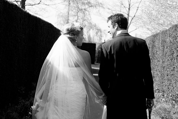 Bride And Groom Walking Through Gardens