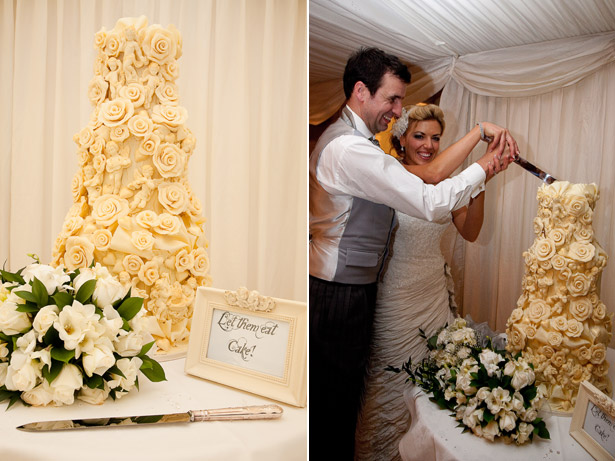 Bride And Groom Cutting Ivory Rose Wedding Cake