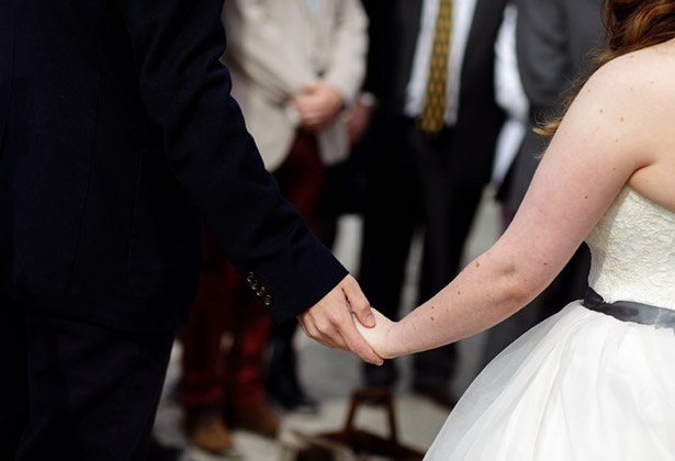 Bride and groom holding hands 