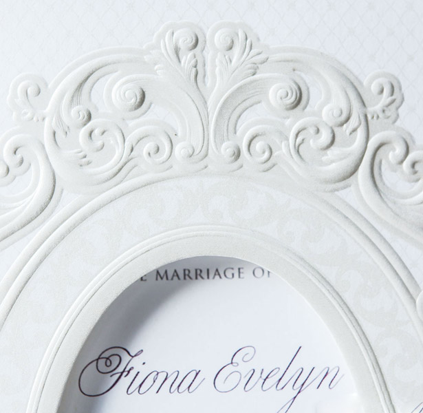 White laser decorated wedding invitation close-up