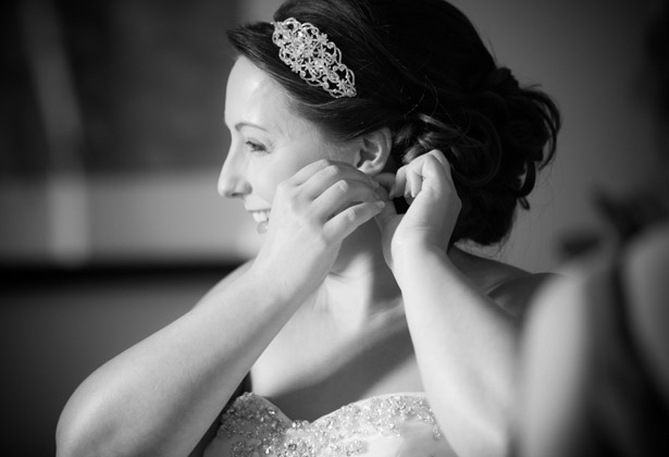 Bride putting her jewellery on