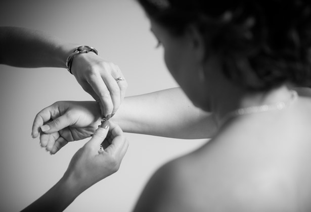 Bride putting her jewellery on