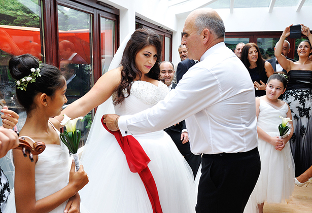 Bride taking part in Greek wedding traditions