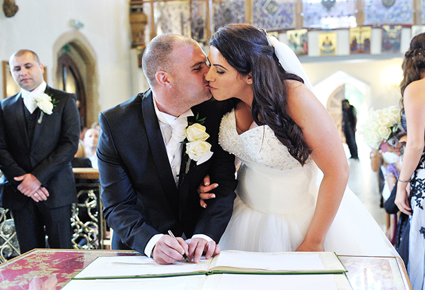 Newlyweds signing the register