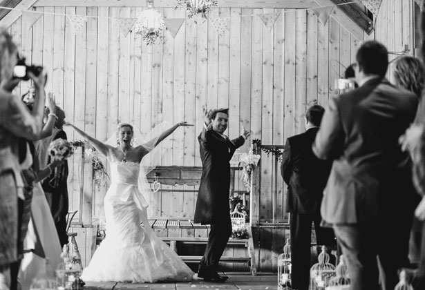 Bride and groom dancing down the aisle 