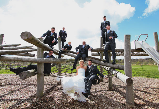 The bride and groom with the groomsmen by Sansom Photography 