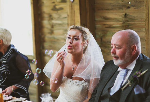 Bride blowing bubbles