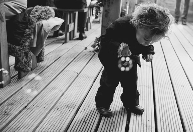 Young wedding guest playing