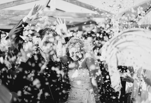 Guests throwing confetti over the newlyweds 