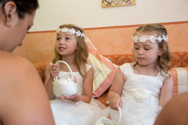 Flower girls in white dresses and floral head bands