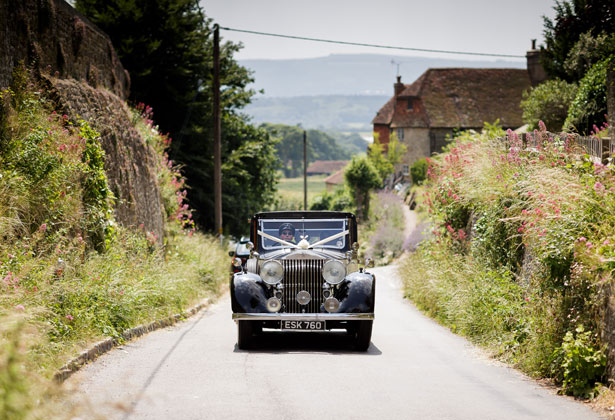 Bride in a black vintage car on her way to the ceremony 