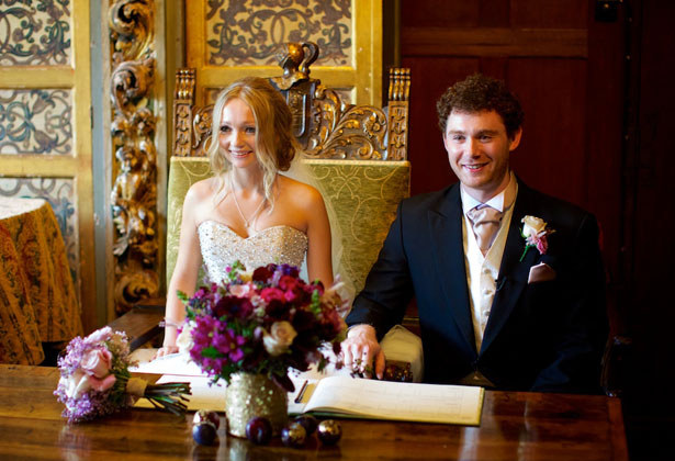 The newlyweds signing the register  