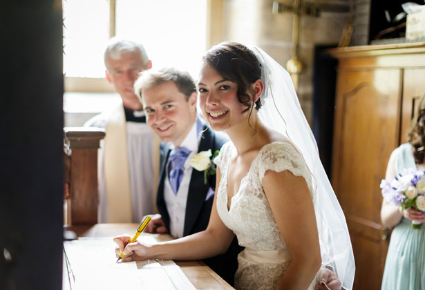 The newlyweds signing the register 