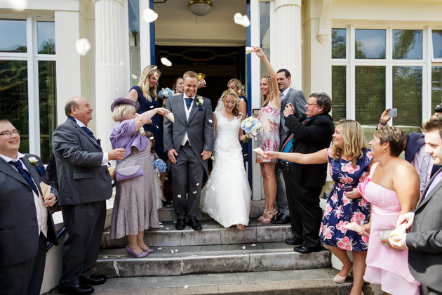 Guests throwing confetti on the newlyweds