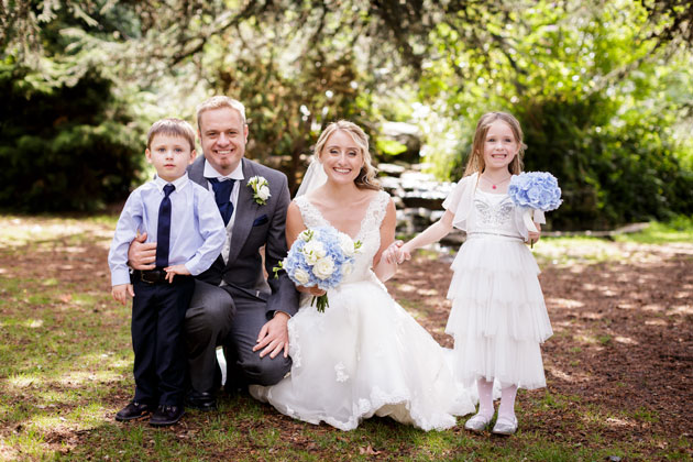 The bride and groom with their flower girl by Douglas Fry Photography