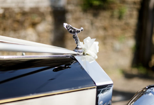 Vintage wedding car with white ribbon  