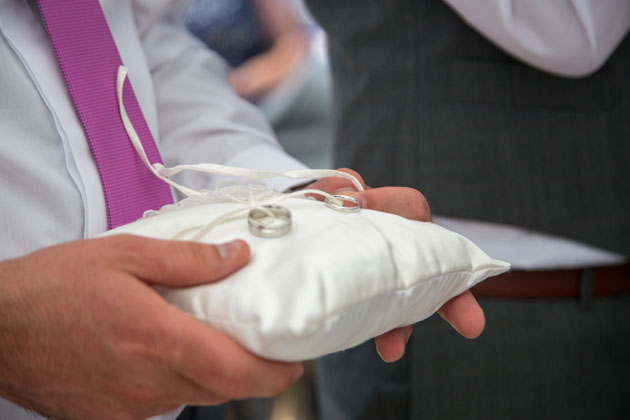 The wedding rings on a ring cushion 