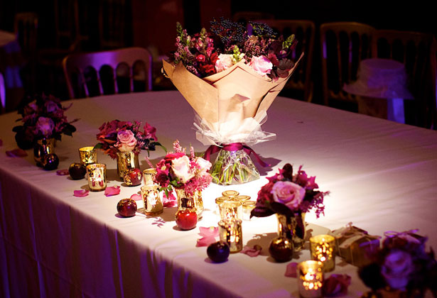 Champagne and rich purple wedding flowers on the top table 