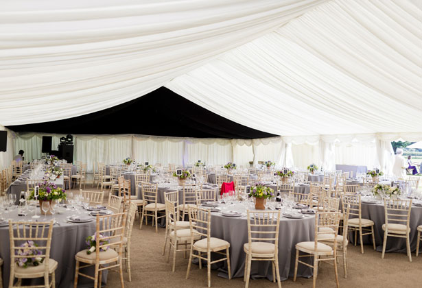 Marquee wedding with purple, yellow and green centrepieces 