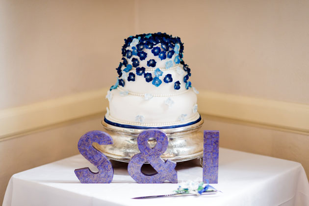 White wedding cake with blue flowers 