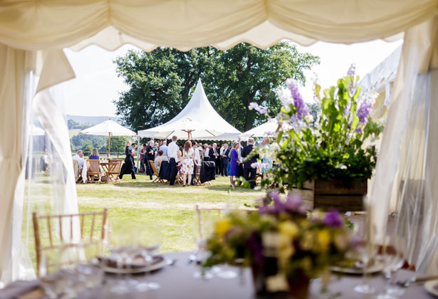 Marquee wedding with purple, yellow and green centrepieces