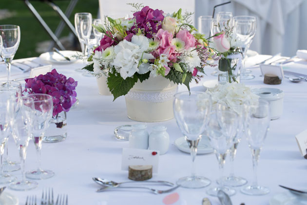  Pink and white wedding centrepiece with white table setting 