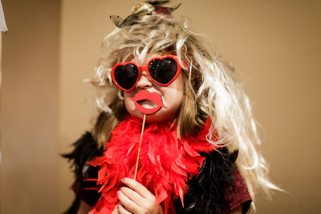 Wedding guests wearing the photo booth props 