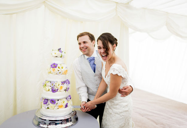 Bride and groom cutting the wedding cake