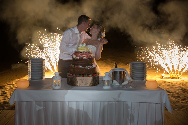 Bride and groom cutting the wedding cake